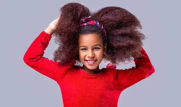 Smile little african american girl. African American girl smile and curly hair. Laughing cute afro girl portrait. Cute multiracial small girl smiling.