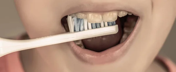 Little boy cleaning teeth. Dental hygiene. Happy little kid brushing her teeth. Kid boy brushing teeth. Boy toothbrush white toothpaste. Health care, dental hygiene.