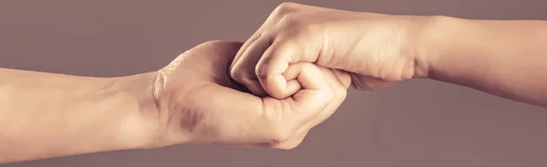 Male hand united in handshake. Man help hands, guardianship, protection. Two hands, isolated arm, helping hand of a friend. Rescue, helping hand.