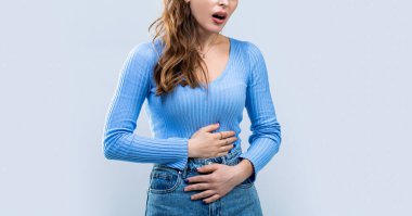 Woman touching his stomach. Stomach pain and others stomach disease concept. Girl having a stomachache. Young woman suffering from abdominal pain. Woman Stomach Ache. clipart