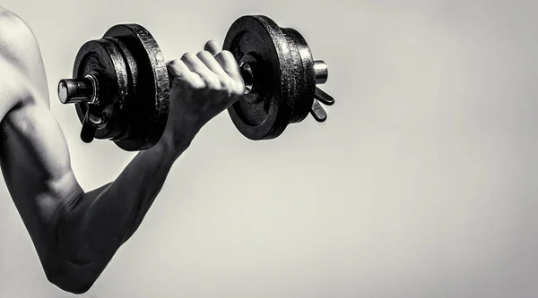 stock image Weak man lift a weight, dumbbells, biceps, muscle, fitness. Man holding dumbbell in hand. Black and white.