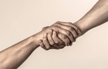 Lending a helping hand. Handshake, arms friendship. Friendly handshake, friends greeting, teamwork, friendship. Close-up. Rescue helping gesture or hands clipart