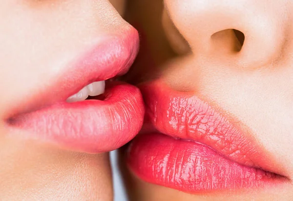 Lesbian couple kiss lips. Passion and sensual touch. Closeup of women mouths kissing. Two beautiful sexy lesbians in love. Lip care and beauty.