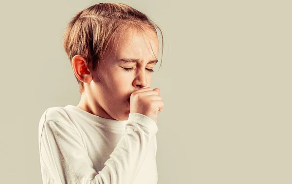 Child is ill, he coughs. Treatment of colds and flu. Boy coughing sick colds sneezing cough. Child got sick with a virus. Children coughs.