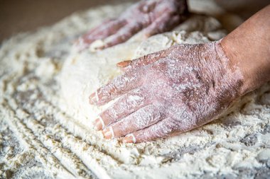 Mutfakta şef mangır hazırlar. Hazırlık hamurları. Eller hamur. Kadın eli pizza için hamur yapıyor..