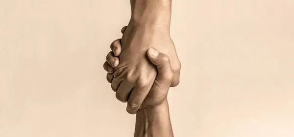 Helping hand concept and international day of peace, support. Helping hand outstretched, isolated arm, salvation. Close up help hand. Two hands, helping arm of a friend, teamwork.