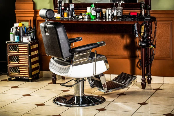 Stylish vintage barber chair. Professional hairstylist in barbershop interior. Barber shop chair. Barbershop armchair, modern hairdresser and hair salon, barber shop for men.
