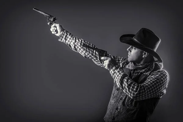 Man wearing cowboy hat, gun. Western man with hat. Portrait of a cowboy. Portrait of a cowboy. Black and white.