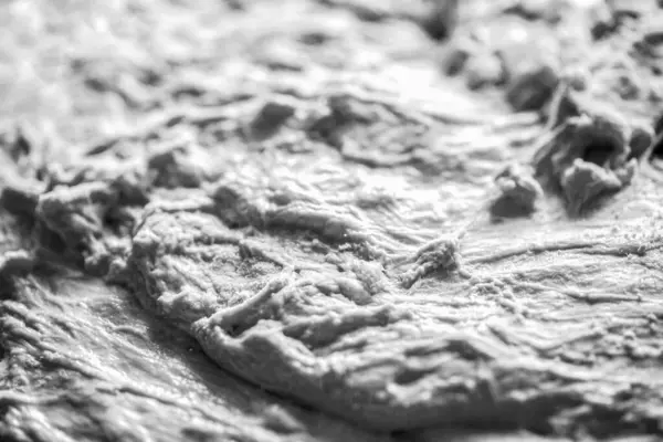 Background of the dough for baking. Fresh raw dough for pizza or bread baking. Fermented doughs, homemade. Black and white.