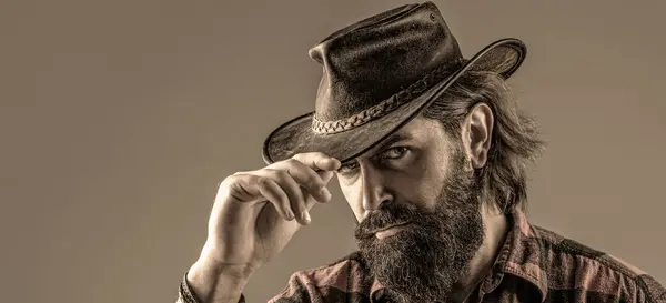American cowboy. Leather. Cowboy Hat. Portrait of young man wearing cowboy hat. Cowboys in hat. Handsome bearded macho.
