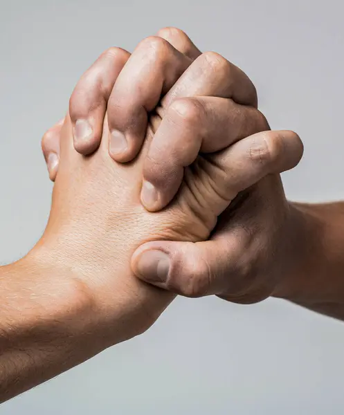 Male and female hand united in handshake. That could mean help, guardianship, protection. Male hand united in handshake. Man help hands, guardianship, protection. Friendly handshake, friends greeting.