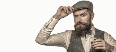 Adamın elinde viski ya da viski var. Sakallı adam bardağı alkolle tutuyor. Meraklı suratlı barmen ya da degustatör elinde bir bardak konyak tutuyor. Sakallı adam takım elbise giyip viski, brendi, konyak içiyor..