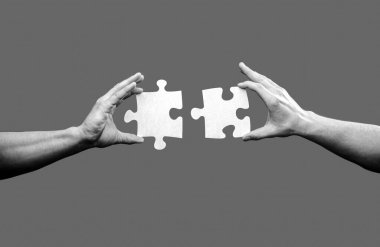 Holding puzzle. Business solutions, success and strategy concept. Black and white. clipart