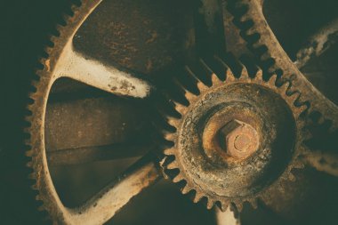 Rusty large gears from old mechanism photographed at close range.