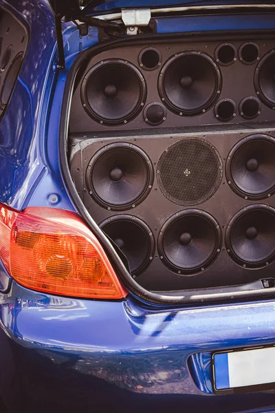 The inside of a car trunk full of stereo speakers.