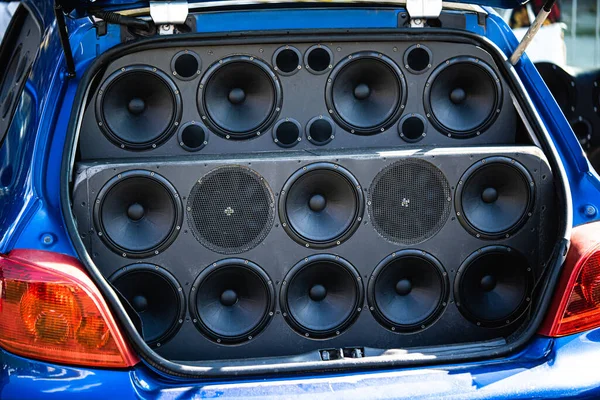 The inside of a car trunk full of stereo speakers.