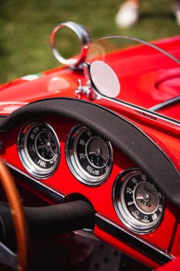 Close up shot of a speedometer and other gauges on an old vintage car.
