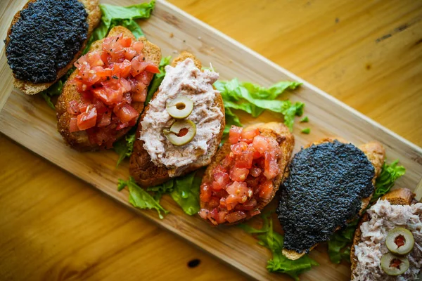 stock image Selection of Spanish tapas served on a sliced baguette