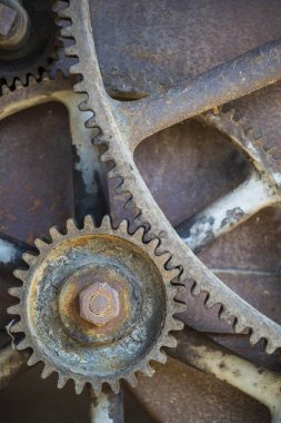 Rusty large gears from old mechanism photographed at close range.