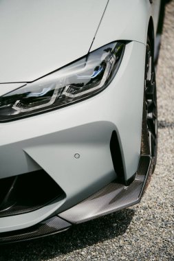 Close up shot of a red modern exotic sports car LED headlights.