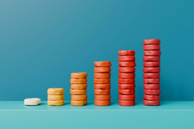 Mavi arka planda oyun hamurundan yapılmış yükselen bir bar çizelgesi. Yüksek kalite fotoğraf