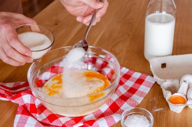 Kitchen. Cook. A man prepares pancake dough in a glass bowl.