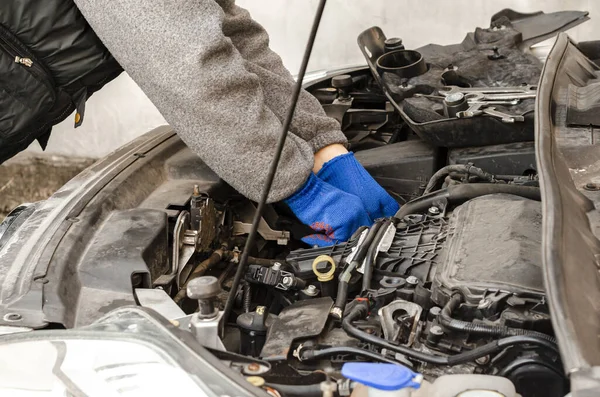 Repair of a car with a diesel engine. Auto Mechanics Hands