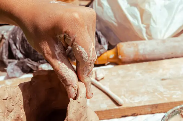 Potter\'s hands close-up. Clay products. Fine hand motor skills
