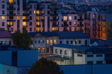Geceleri yatma bölgesinde apartman blokları. Akşam karanlığında şehir havası, artan elektrik fiyatları.