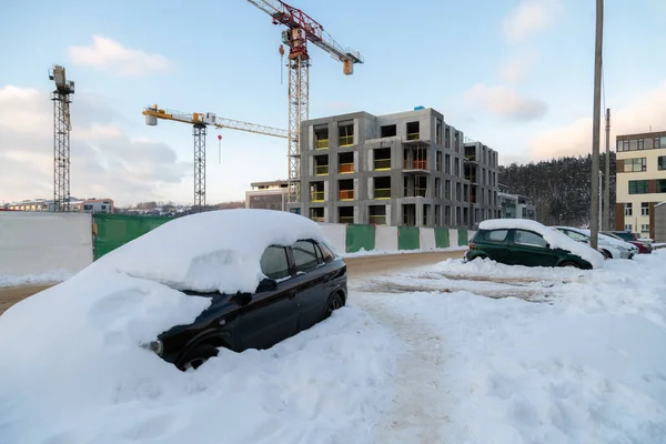 Unfinished constructions of apartments during winter. Housing crisis, building companies go bankrupt and leave unfinished buildings.