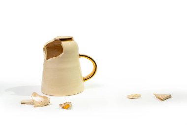 Broken tea cup isolated on white background. Cracked coffee mug and fragile ceramic pieces