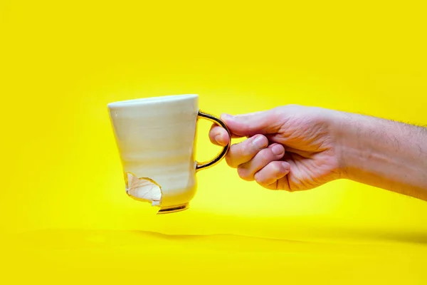 Man Holding Broken Tea Cup Isolated Yellow Background Close Arm — Photo