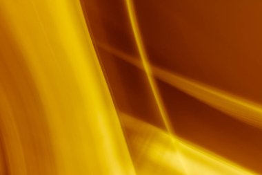 Golden brown abstract background banner from the intersection of flowing rays with a gradient. Backdrop