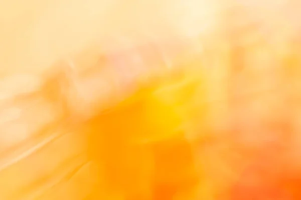 オレンジ色の黄色の色調で暖かい背景があり ボケ味の強い光と柔らかいグラデーションが特徴です カラフルな背景 — ストック写真