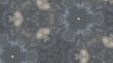 Üzerinde güneş lekeleri ve kaleydoskop desenleri olan Grunge beton arka planı..