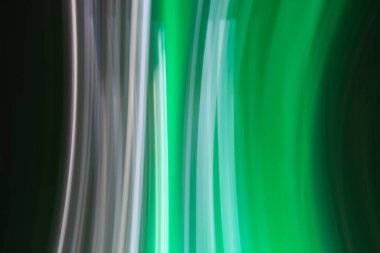 An abstract image featuring vertical streaks of light in shades of green, white, and black. The light trails create a sense of motion and fluidity, reminiscent of lights captured in motion photography clipart
