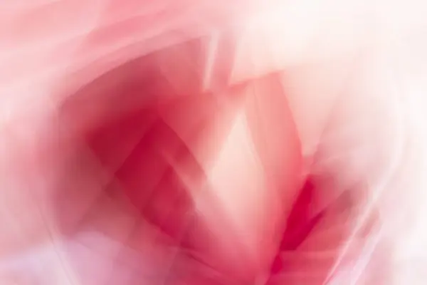 stock image An abstract image showing flowing shades of red, pink, and white. The soft, blurred lines create a sense of movement and fluidity.