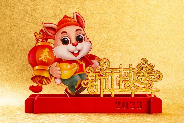 stock image Chinese New Year of Rabbit mascot on golden background the Chinese words means springtime and happy Chinese new year no logo no trademark