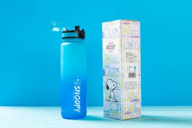 ZhongShan China-June 19,2022:giant size blue plastic water bottle for boy on a wood table.