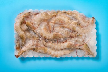 top view frozen prawns on blue horizontal composition