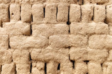 Arka plan ve doku olarak çamur tuğlalarından oluşan duvar
