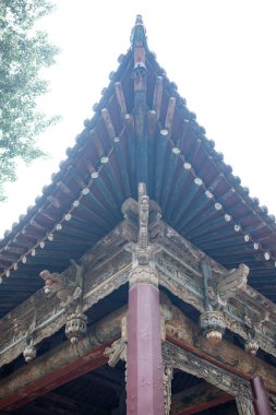 Geleneksel Çin tapınağı çatısının köşesinde dikey kompozisyonda.