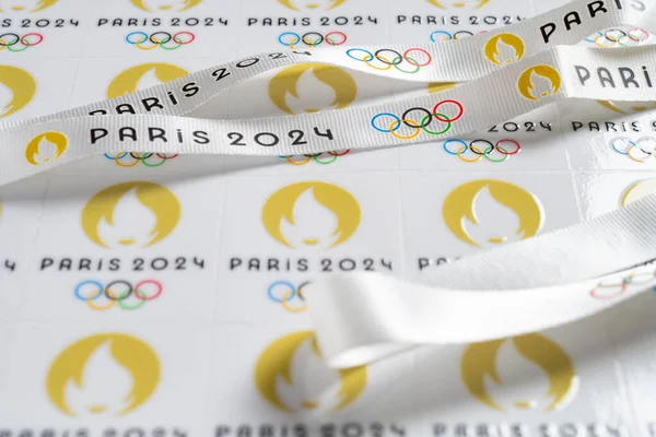 stock image ZHONGSHAN China-September 9,2023:angle view strap and labels printed with Paris Olympic Games 2024 logo horizontal composition.