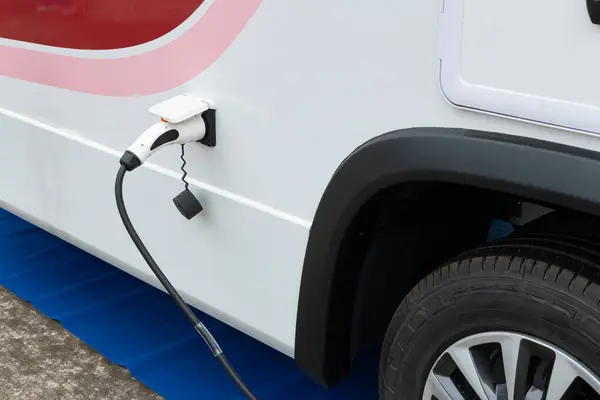 an electrical car being charged horizontal composition