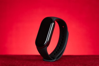 Kırmızı arka planda siyah akıllı bilezik