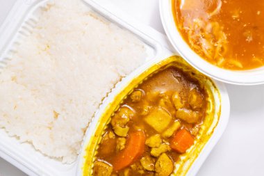 Pirinçli körili tavuk ve yatay kompozisyonda yengeç yumurtası aromalı çorba.