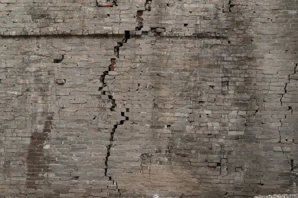 a dangerous wall with large cracks at horizontal composition