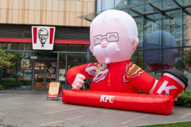 QingYuan GuangDong China-February 14 2024:Colonel Harland Sanders Balloon Model in front of a shopping mall at horizontal composition. clipart