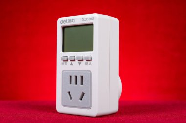 ZHONGSHAN China-March 30;2024:power consumption testing device on red. clipart