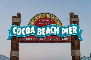 Cocoa Beach, Florida - December 29, 2022: Illuminated neon sign for the Cocoa Beach Pier at dusk
